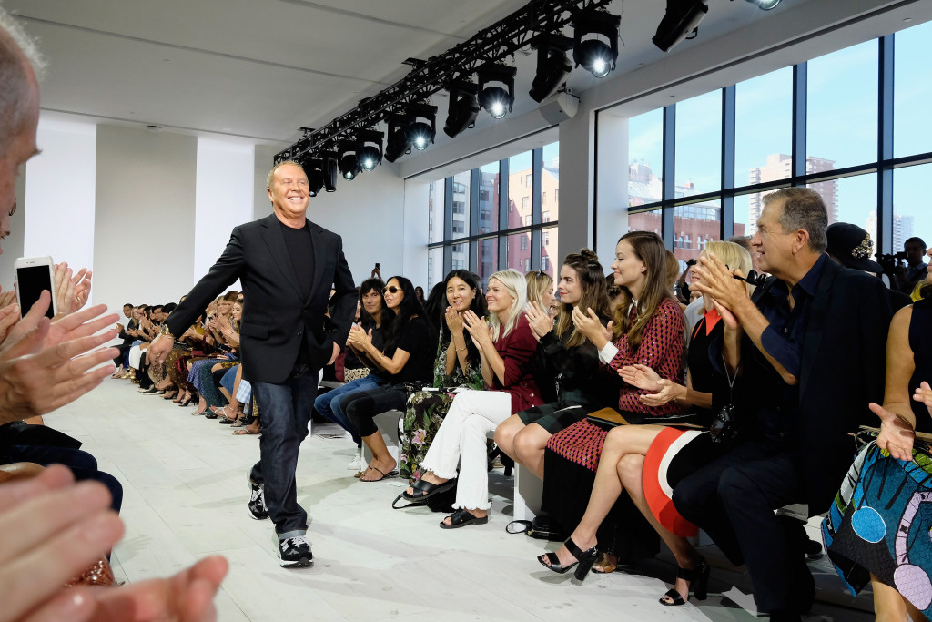 NEW YORK, NY - SEPTEMBER 16:  Designer Michael Kors poses on the runway at the Michael Kors Spring 2016 Runway Show during New York Fashion Week: The Shows at Spring Studios on September 16, 2015 in New York City.  (Photo by Dimitrios Kambouris/Getty Images for Michael Kors)